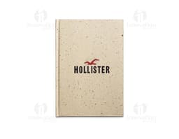Produto: Caderno A5 com resíduos da cevada. Imagem do caderno de tamanho A5 com capa feita de resíduos da cevada.