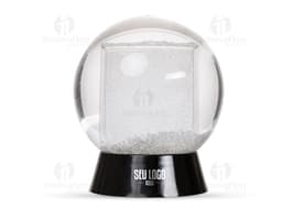 Globo de neve plástico transparente com uma paisagem de neve e uma pequena figura de um boneco de neve no centro.