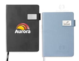 Diskette de papel em formato de caderneta de couro sintético, sobre um notebook. A imagem representa um dispositivo de