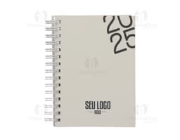 Agenda diária 2025 Wire-o com capa dura na cor preta e detalhes em dourado, apresentando páginas internas decoradas com