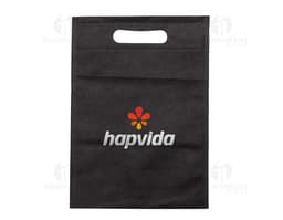 Carteira preta, bolsa de papelão vazia, notebook com quadro negro ao fundo, antigo cartão de memória em cima de um caderno de
