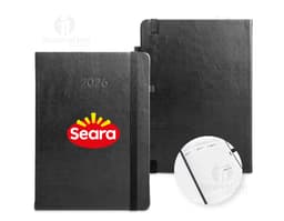 Agenda B5 em PU 2026 em cores cinza e preto, com fechamento de elástico e detalhe dourado na capa.